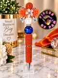 Orange beaded pen with blue focal bead