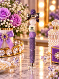 Purple rhinestone beaded pen with metallic bow and decorative double-C motif